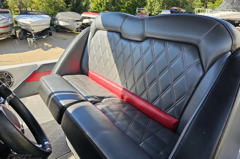 Slide: The Image of 2020 Sunsation 32 CCX boat interior with diamond-stitched black and red seating. - 78