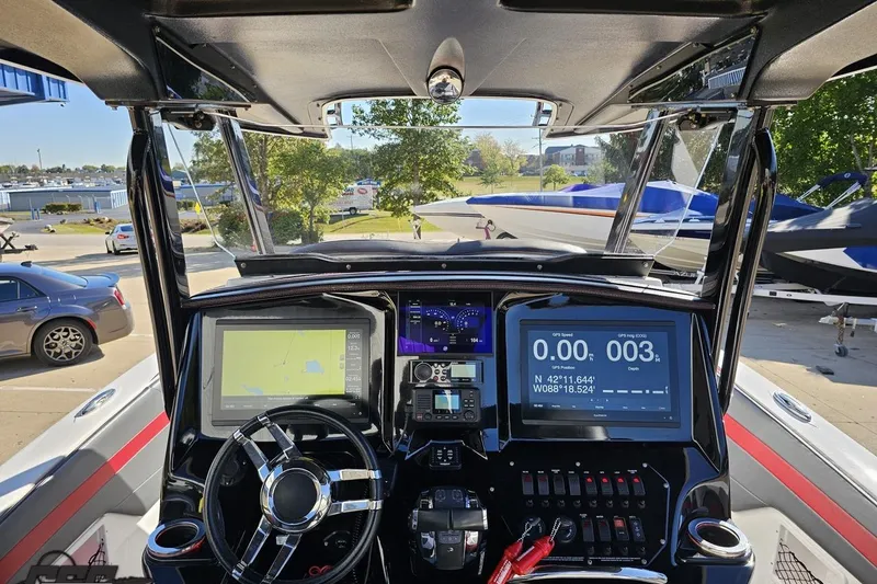 Slide: The Image of 2020 Sunsation 32 CCX boat dashboard with navigation screens and steering wheel. - 80