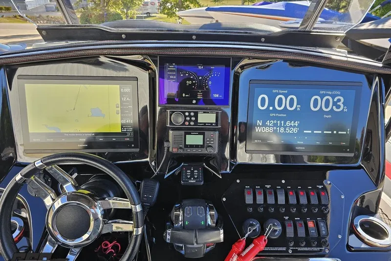 Slide: The Image of Dashboard of a 2020 Sunsation 32 CCX boat with advanced navigation displays. - 81