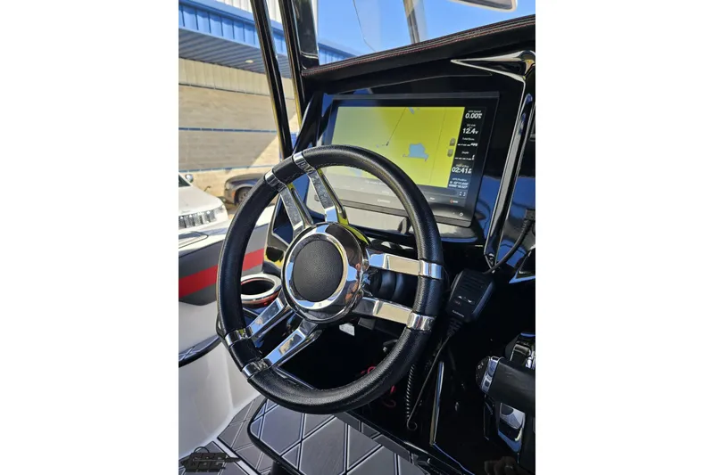 Slide: The Image of 2020 Sunsation 32 CCX boat dashboard with steering wheel and navigation display. - 84