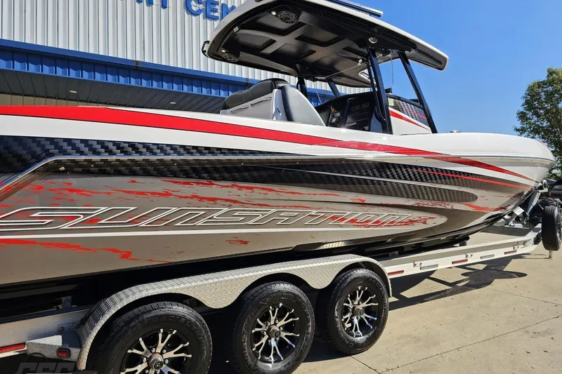 Slide: The Image of 2020 Sunsation 32 CCX boat on trailer, featuring sleek design and vibrant graphics. - 9