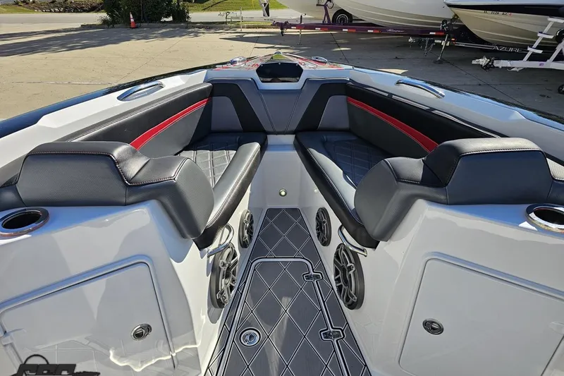 Slide: The Image of 2020 Sunsation 32 CCX boat interior with black and red seating, cup holders, and speakers. - 95