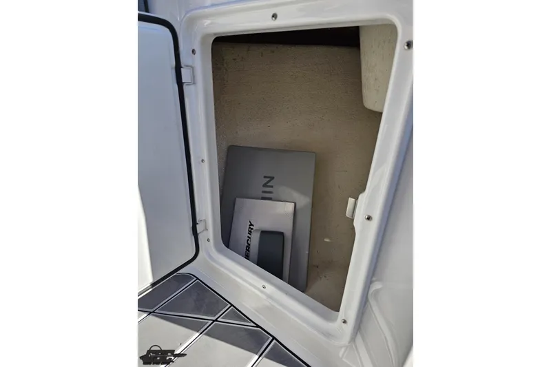 Slide: The Image of Open storage compartment on 2020 Sunsation 32 CCX boat, showing interior space. - 98