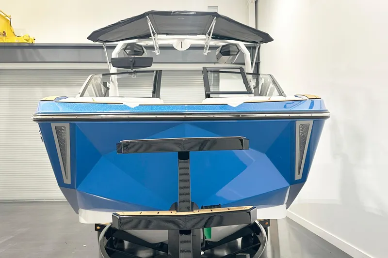Slide: The Image of 2025 Nautique Super Air Nautique G23 boat, blue exterior, displayed indoors. - 3