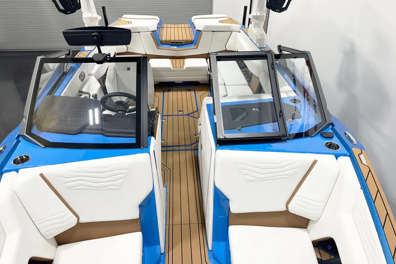 Slide: The Image of 2025 Nautique Super Air Nautique G23 interior with blue accents and white seating. - 6