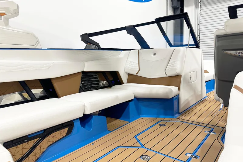 Slide: The Image of 2025 Nautique Super Air Nautique G23 interior with white seating and blue accents. - 9