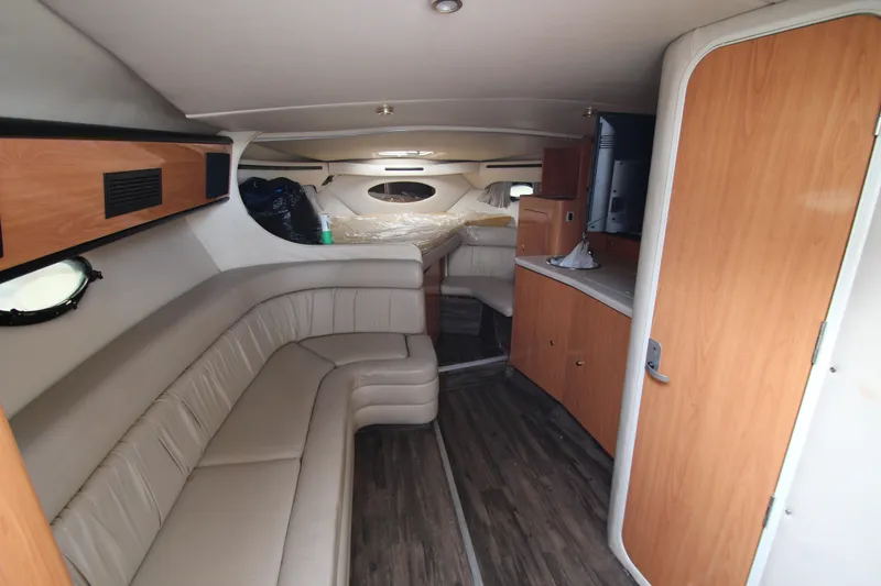 Slide: The Image of Interior of 1999 Regal Commodore 322 yacht with beige seating and wood accents. - 10