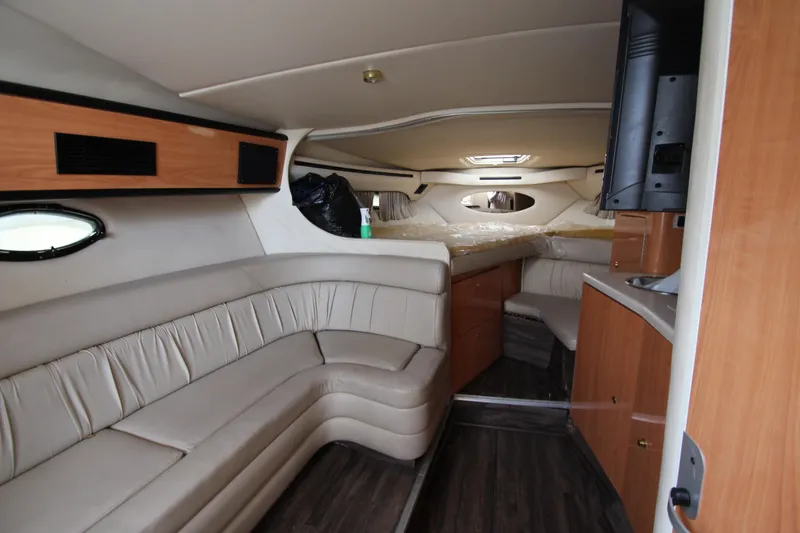 Slide: The Image of Interior of 1999 Regal Commodore 322 yacht with beige seating and wood accents. - 11