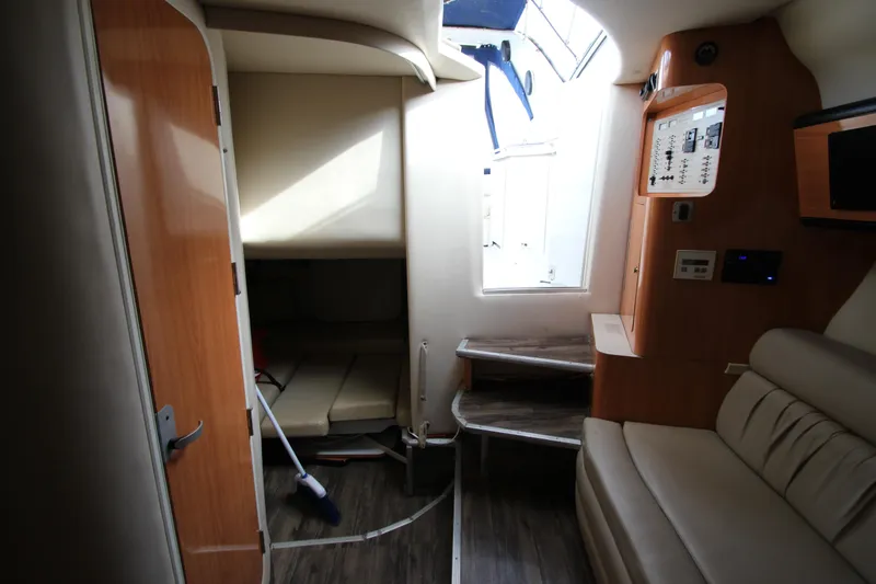 Slide: The Image of Interior of a 1999 Regal Commodore 322 boat, featuring seating and control panel. - 14