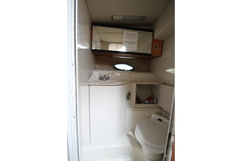 Slide: The Image of 1999 Regal Commodore 322 boat bathroom with sink, mirror, and toilet. - 15
