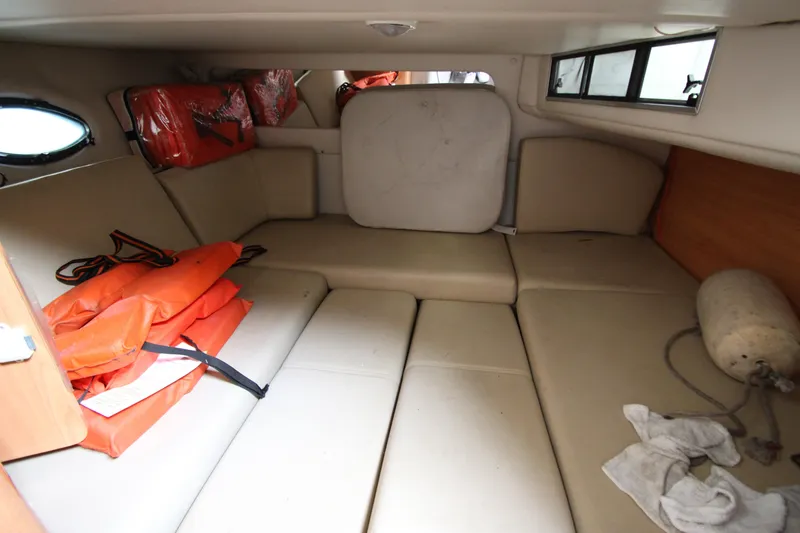Slide: The Image of 1999 Regal Commodore 322 cabin interior with life jackets and seating area. - 16