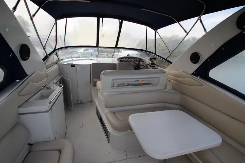 Slide: The Image of Interior of a 1999 Regal Commodore 322 boat with seating and helm. - 19