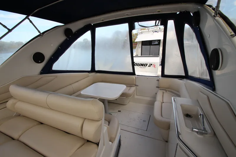 Slide: The Image of Interior of 1999 Regal Commodore 322 yacht with beige seating and table. - 5