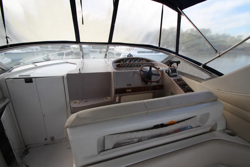 Slide: The Image of Interior view of 1999 Regal Commodore 322 boat cockpit with steering wheel and controls. - 7