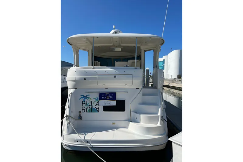 Slide: The Image of 2006 Sea Ray 40 Motor Yacht docked at marina under clear blue sky. - 2
