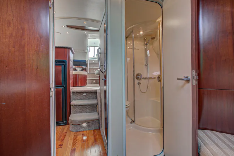 Slide: The Image of Engine room of a 2006 Sea Ray 40 Motor Yacht with visible hoses and components. - 59