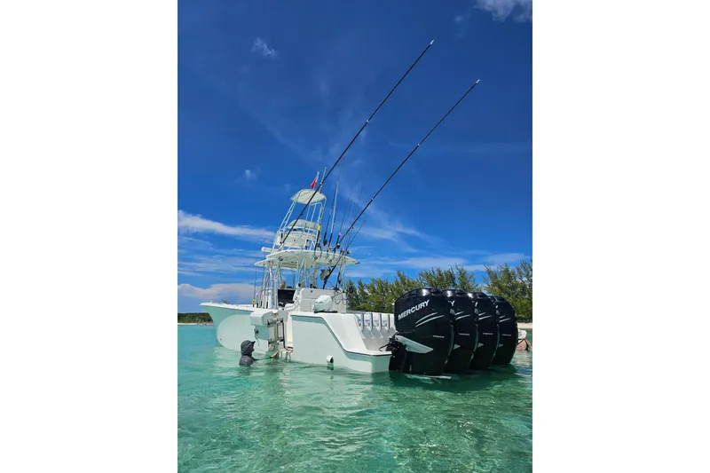 Slide: The Image of 2019 SeaVee 390Z boat with multiple Mercury engines in clear blue water. - 12