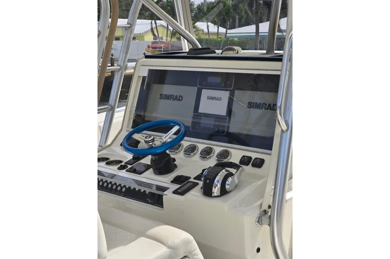 Slide: The Image of 2019 SeaVee 390Z boat dashboard with Simrad navigation system and blue steering wheel. - 6