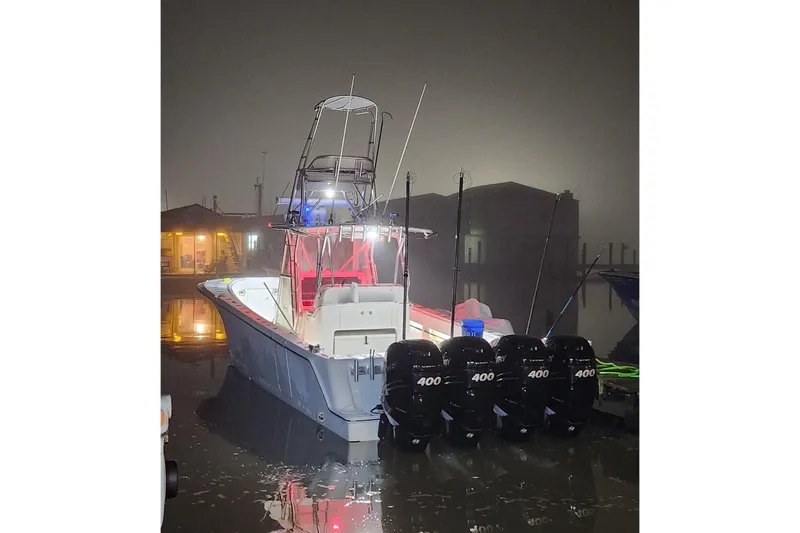 Slide: The Image of 2019 SeaVee 390Z boat with quad 400 engines docked at night. - 8