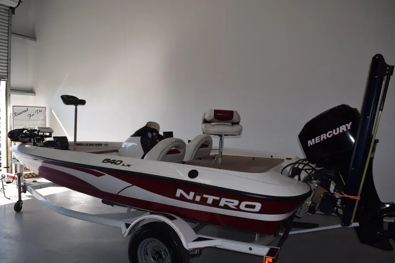 Slide: The Image of 2006 Nitro 640 LX boat with Mercury engine in a garage setting. - 3