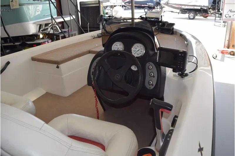 Slide: The Image of Interior of a 2006 Nitro 640 LX boat with steering wheel and dashboard controls. - 5