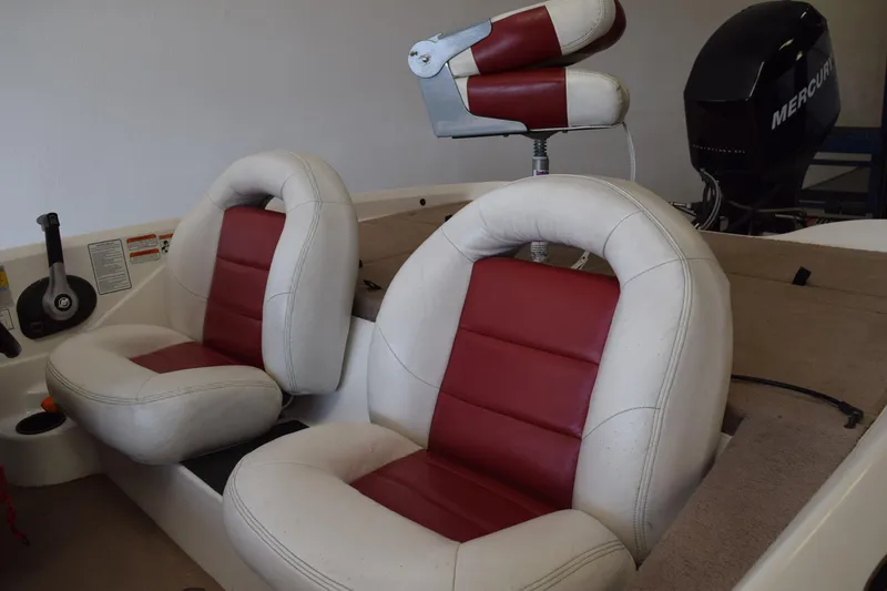 Slide: The Image of 2006 Nitro 640 LX boat interior with red and white seats, Mercury engine visible. - 6