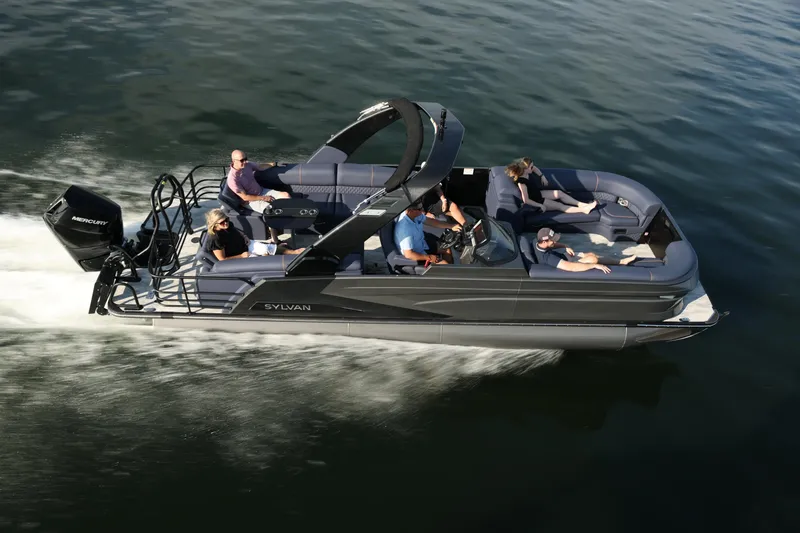 The Image of 2026 Sylvan M-5 CLZ DC pontoon boat cruising on water with passengers. - 1