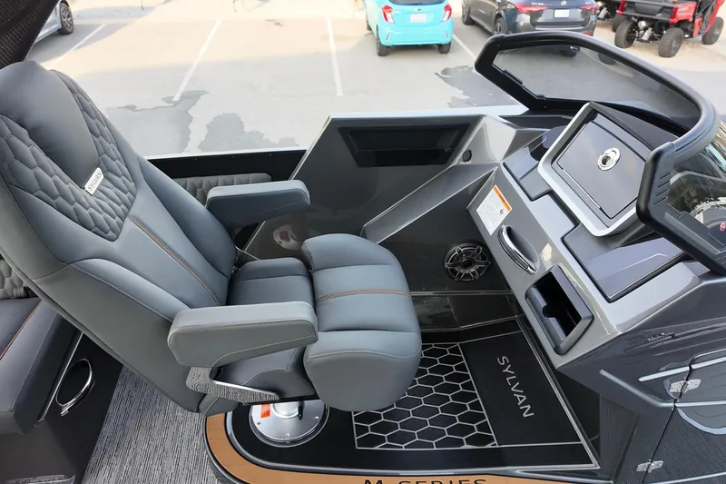 Slide: The Image of Captain's chair and dashboard of 2026 Sylvan M-5 CLZ DC boat, featuring modern design. - 13