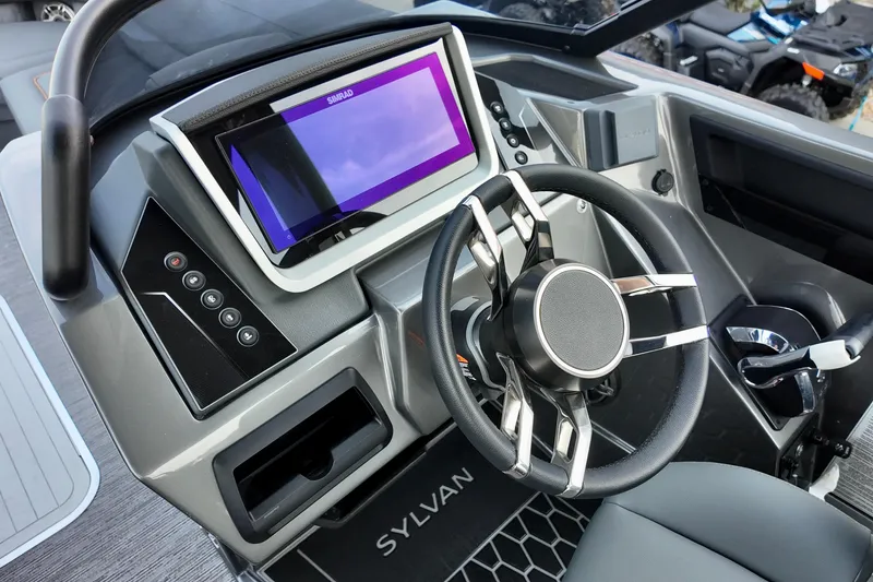 Slide: The Image of 2026 Sylvan M-5 CLZ DC boat dashboard with steering wheel and touchscreen display. - 14