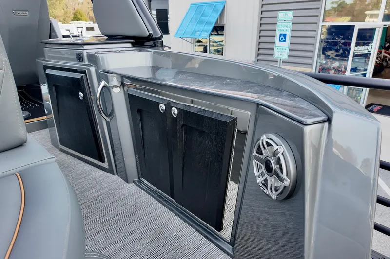 Slide: The Image of 2026 Sylvan M-5 CLZ DC boat interior with sleek cabinetry and speaker system. - 18