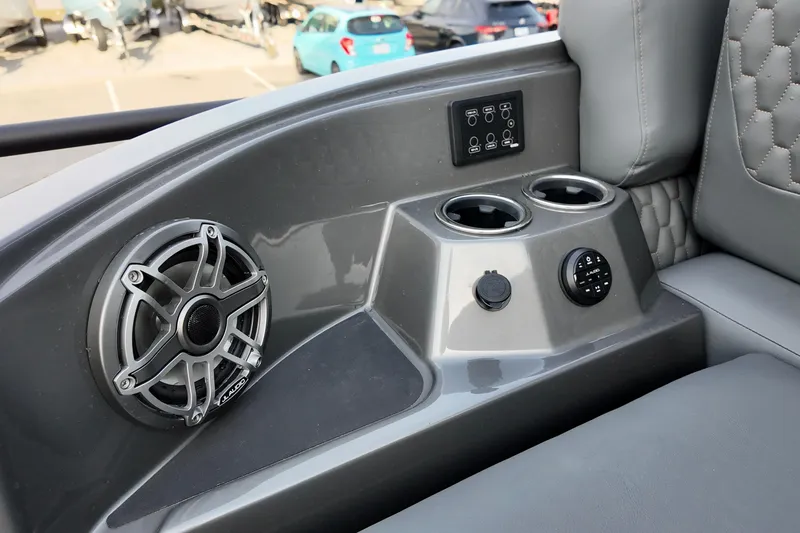 Slide: The Image of 2026 Sylvan M-5 CLZ DC boat interior with speaker, cup holders, and control panel. - 19