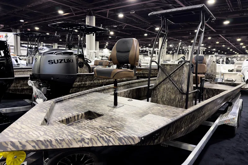 The Image of 2026 Excel 216 Stalker Center Console boat with Suzuki engine at indoor exhibition. - 0