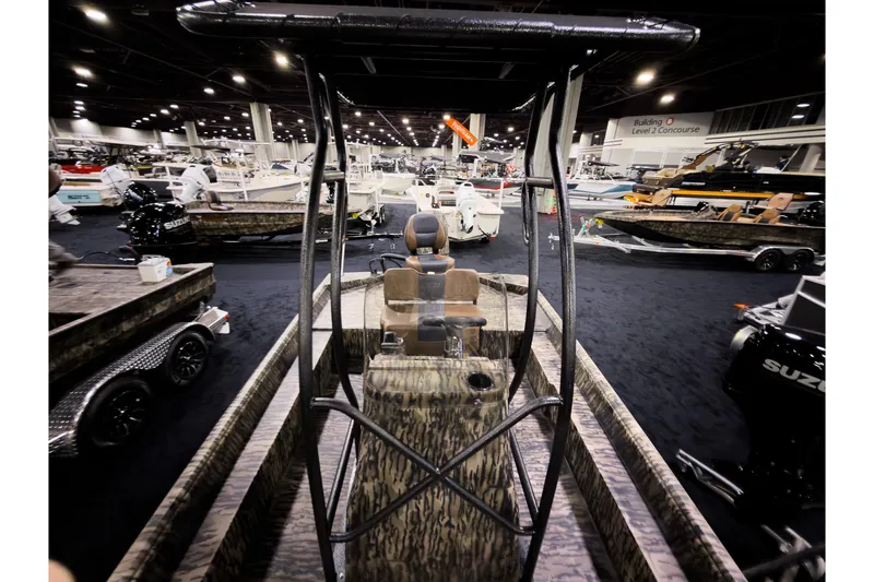 Slide: The Image of 2026 Excel 216 Stalker Center Console boat displayed at an indoor boat show. - 14