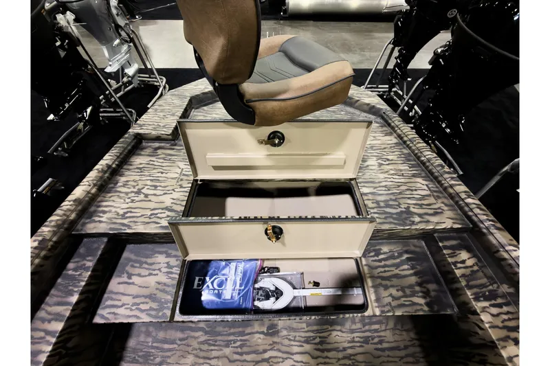 Slide: The Image of 2026 Excel 216 Stalker Center Console boat interior with storage compartments open. - 15