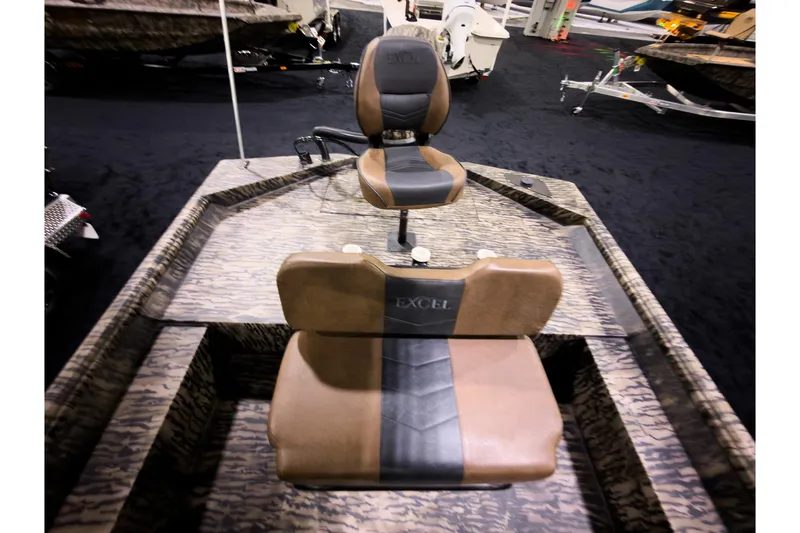Slide: The Image of 2026 Excel 216 Stalker Center Console boat with camo design and comfortable seating. - 9