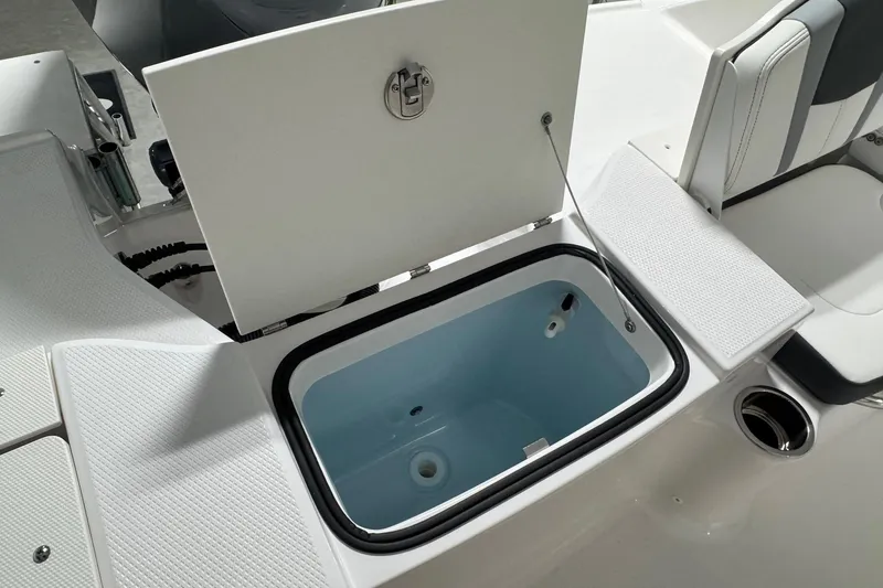 Slide: The Image of 2026 Robalo R200 Center Console boat with open storage compartment. - 16