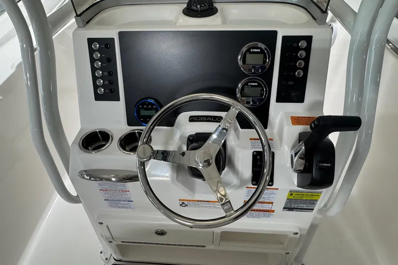 Slide: The Image of 2026 Robalo R200 Center Console boat dashboard with steering wheel and controls. - 6