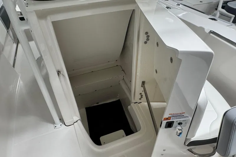 Slide: The Image of 2026 Robalo R200 Center Console boat storage compartment, open and empty. - 9