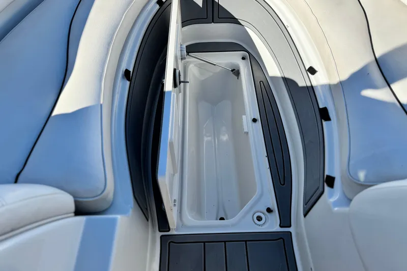 Slide: The Image of Open storage compartment on 2006 Crownline 260 EX boat, featuring sleek interior design. - 15