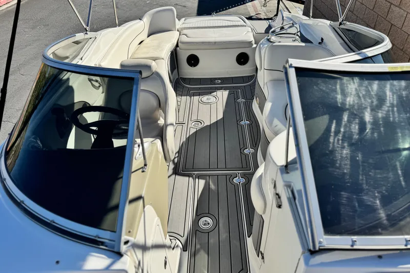 Slide: The Image of 2006 Crownline 260 EX boat interior with seating and steering wheel, featuring sleek design. - 16