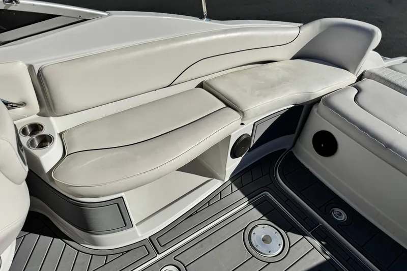 Slide: The Image of 2006 Crownline 260 EX boat interior with cushioned seating and cup holders. - 17