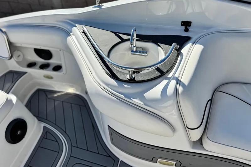 Slide: The Image of 2006 Crownline 260 EX boat interior with sleek seating and built-in sink. - 18