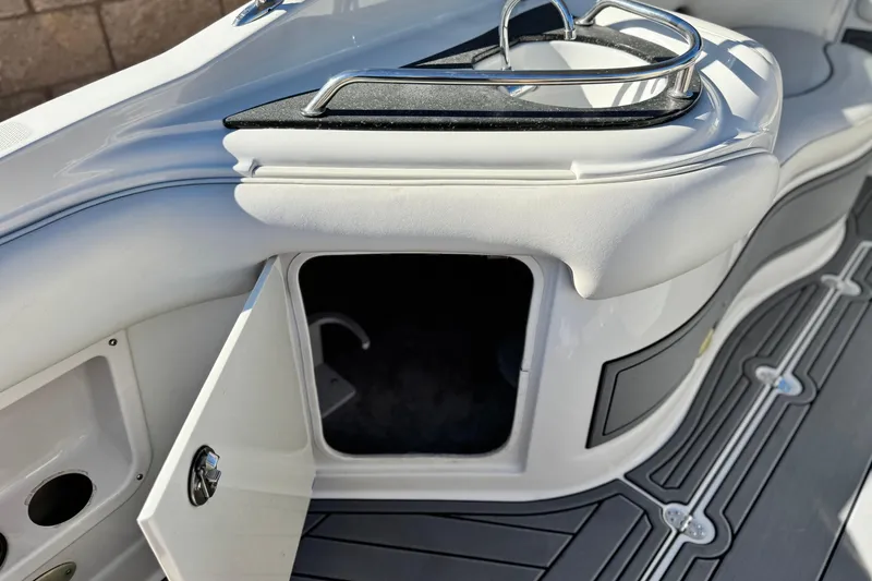 Slide: The Image of 2006 Crownline 260 EX boat interior with open storage compartment and sleek design. - 19