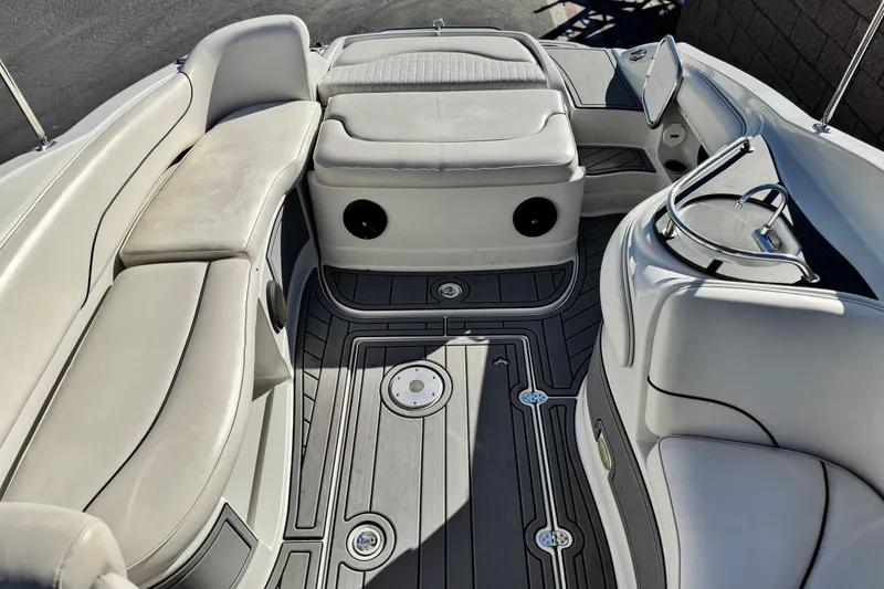Slide: The Image of 2006 Crownline 260 EX boat interior with cushioned seating and sleek flooring. - 21
