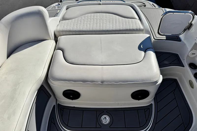 Slide: The Image of 2006 Crownline 260 EX boat interior with cushioned seating and storage compartment. - 22