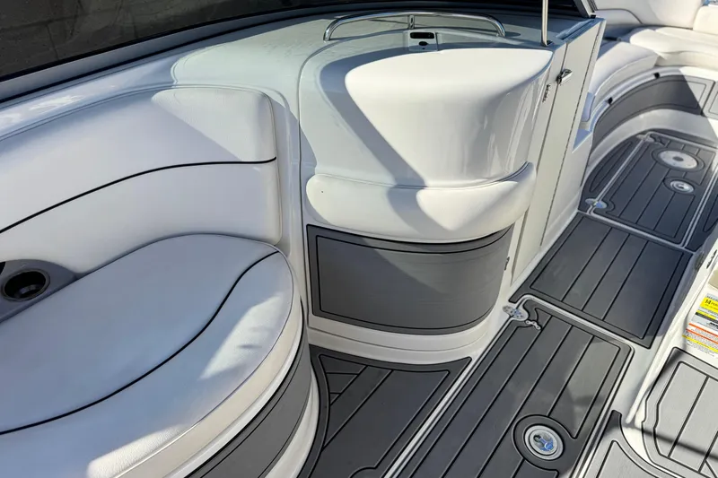 Slide: The Image of 2006 Crownline 260 EX boat interior with white seating and gray flooring. - 26