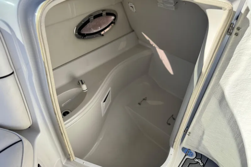 Slide: The Image of 2006 Crownline 260 EX boat interior with compact bathroom and porthole window. - 27