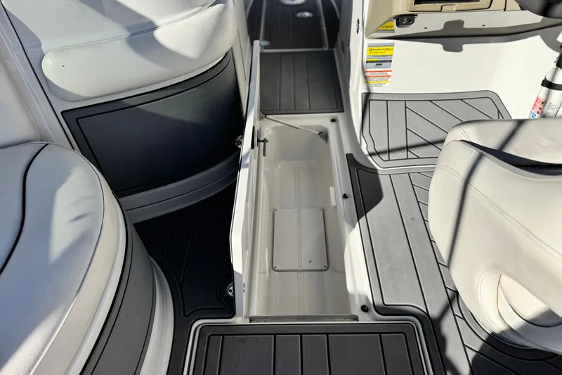 Slide: The Image of 2006 Crownline 260 EX boat interior with open storage compartment and seating. - 28