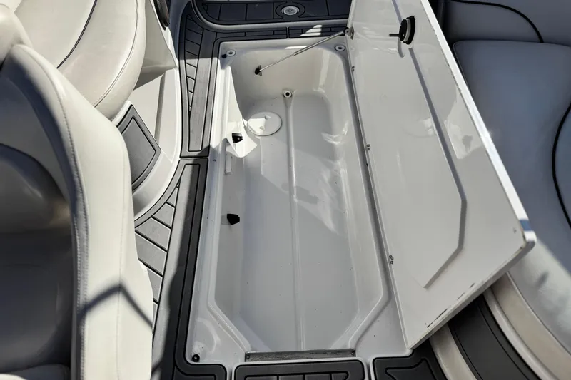 Slide: The Image of Open storage compartment on 2006 Crownline 260 EX boat, featuring sleek interior design. - 29