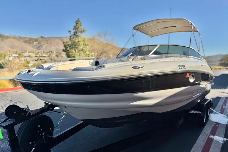 Slide: The Image of 2006 Crownline 260 EX boat on trailer, scenic mountain background. - 3